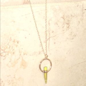 Gold chain necklace with green pendant stone.